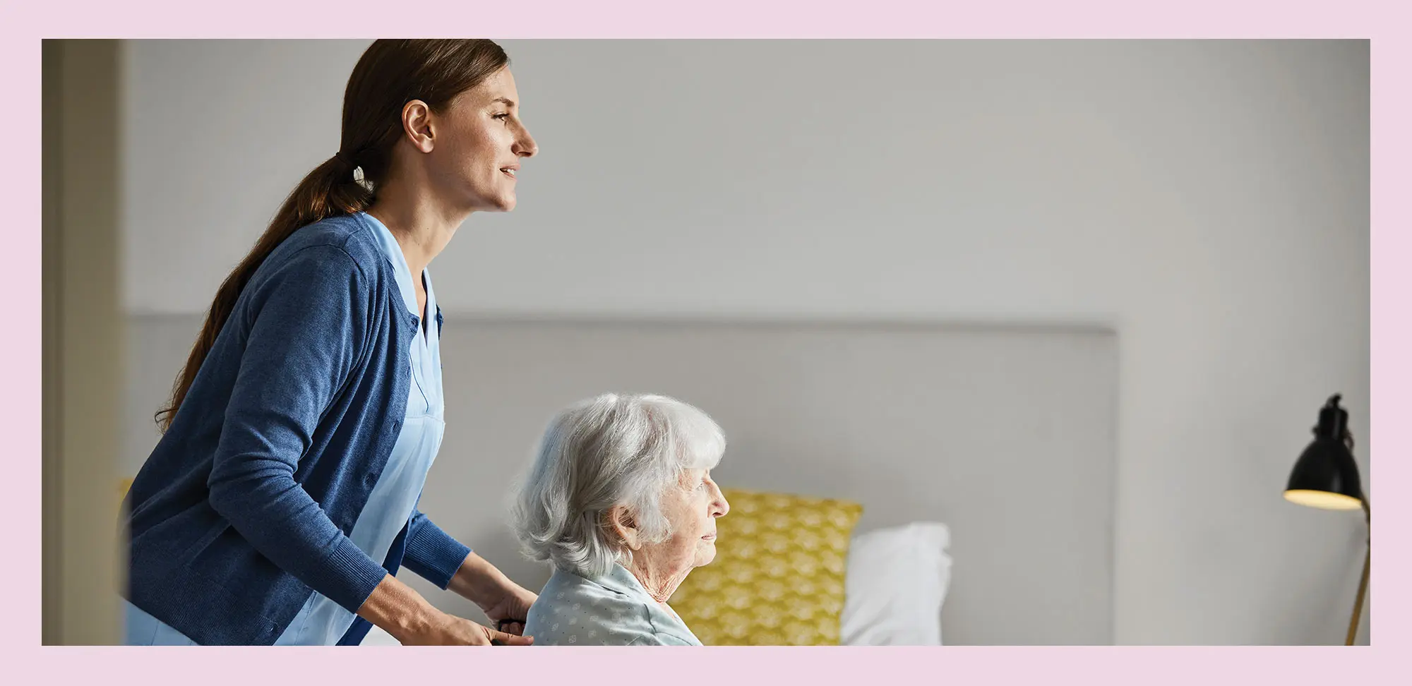 Photo of a Nurse with elderly woman on wheelchair at home