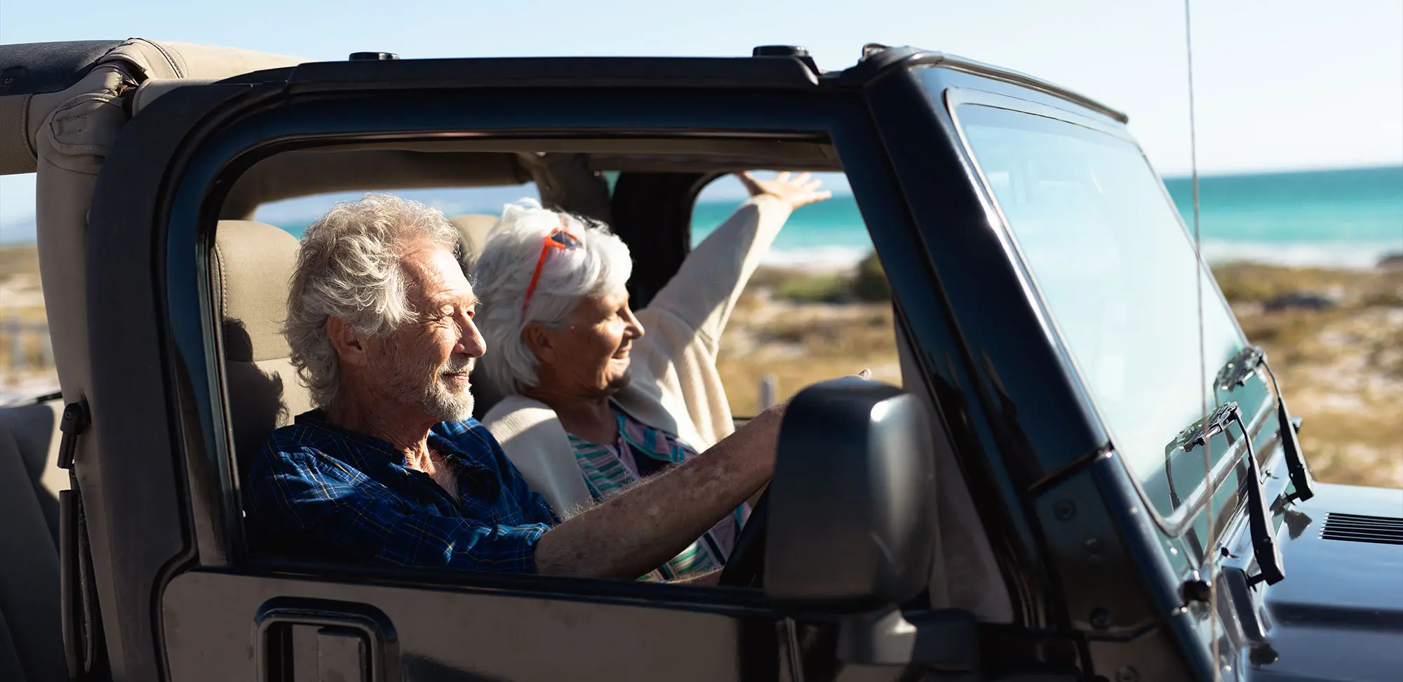 Photo of a couple on a roadtrip in a jeep