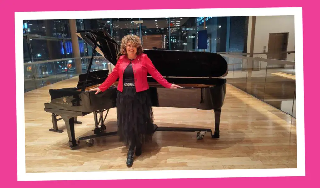 Photo of Dawn Martens standing in front of a grand piano