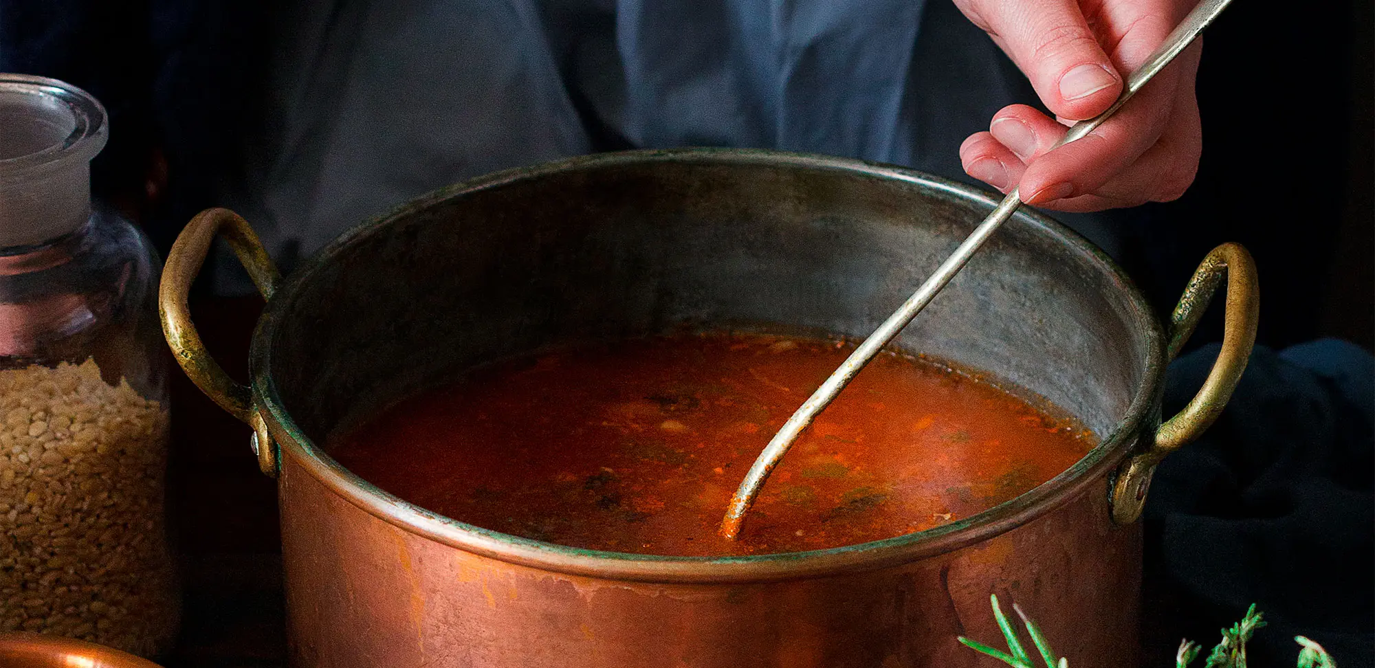 Photo of a woman stirring soup