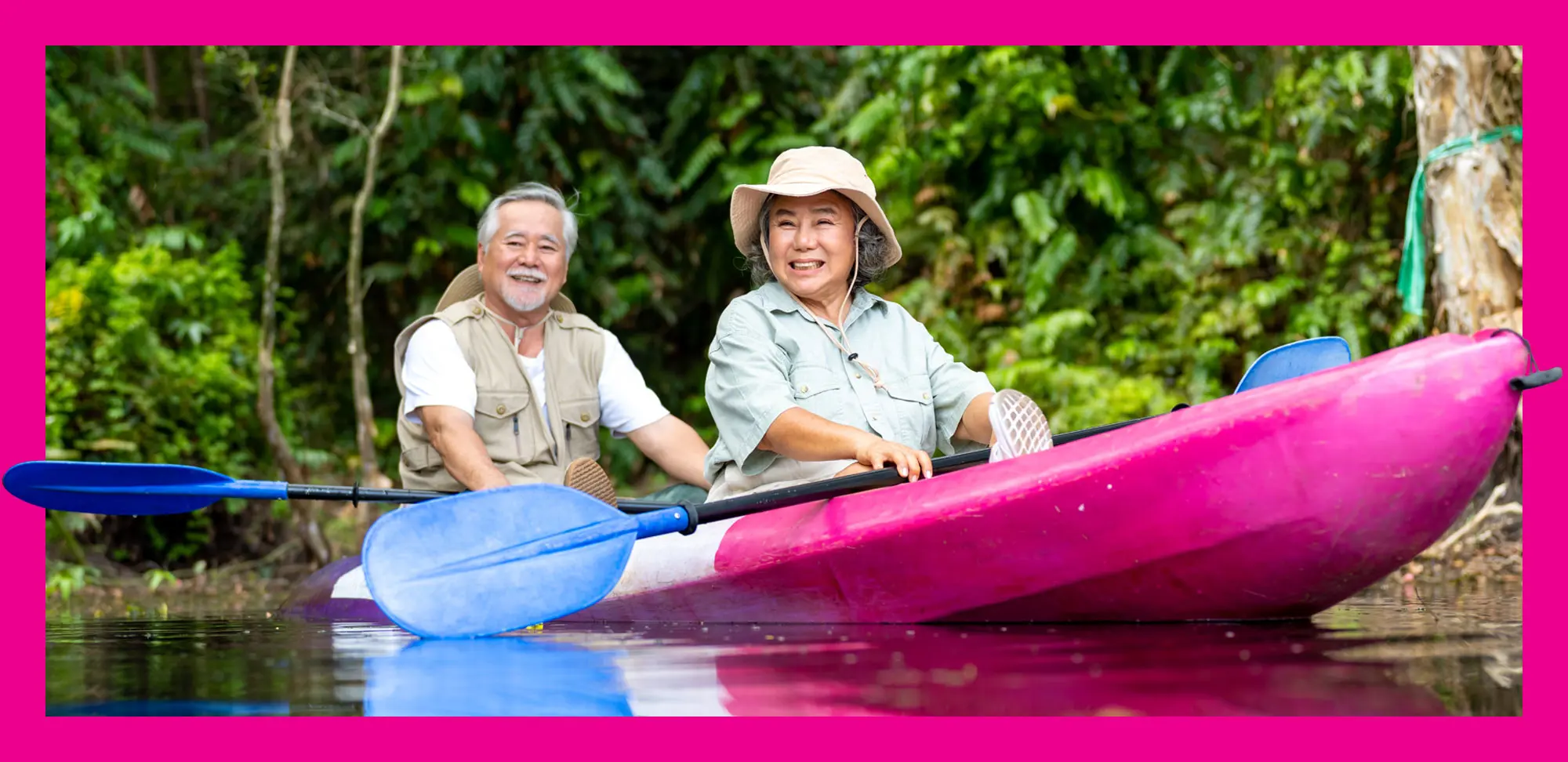 Photo of elderly couple enjoying fun rowing a kayak