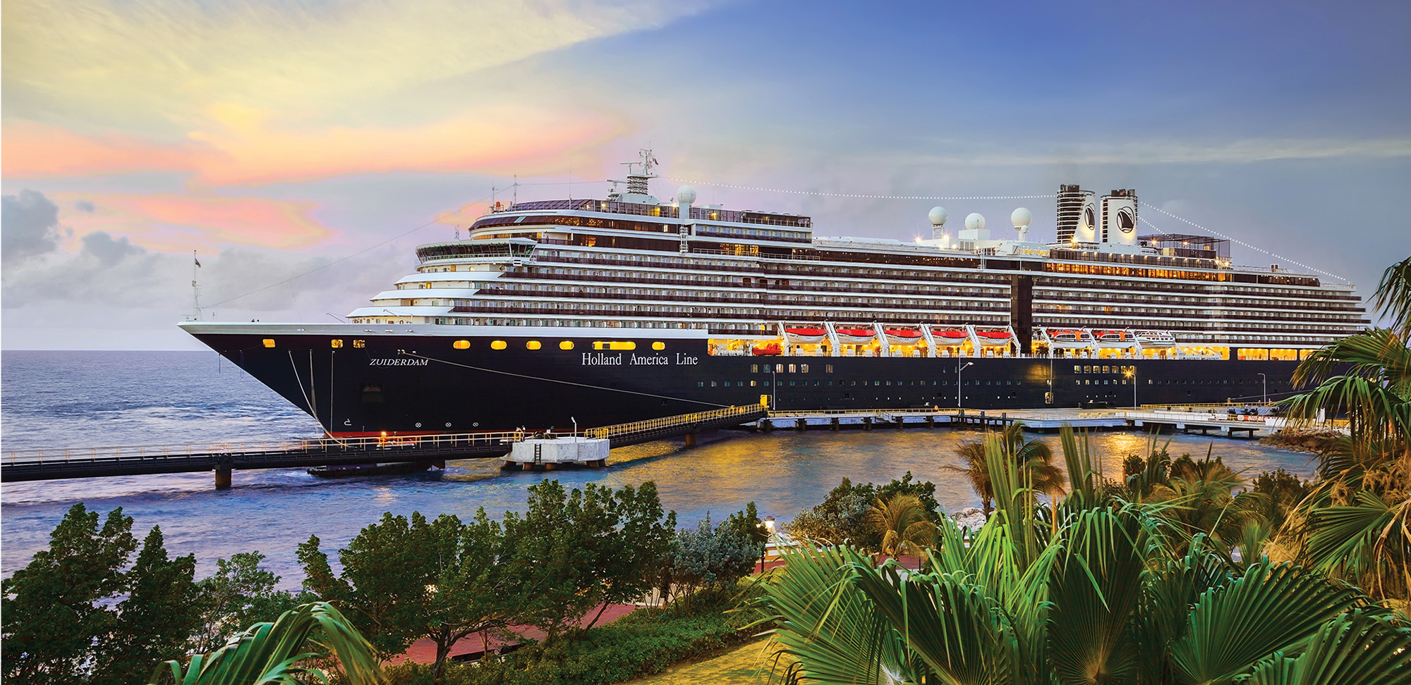 Cruise ship Zuiderdam, Holland America Line, docked at port Willemstad at sunset.