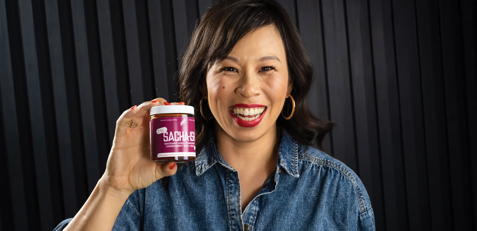 Photo of Pay Chen holding a jar of Sacha-ish sauce