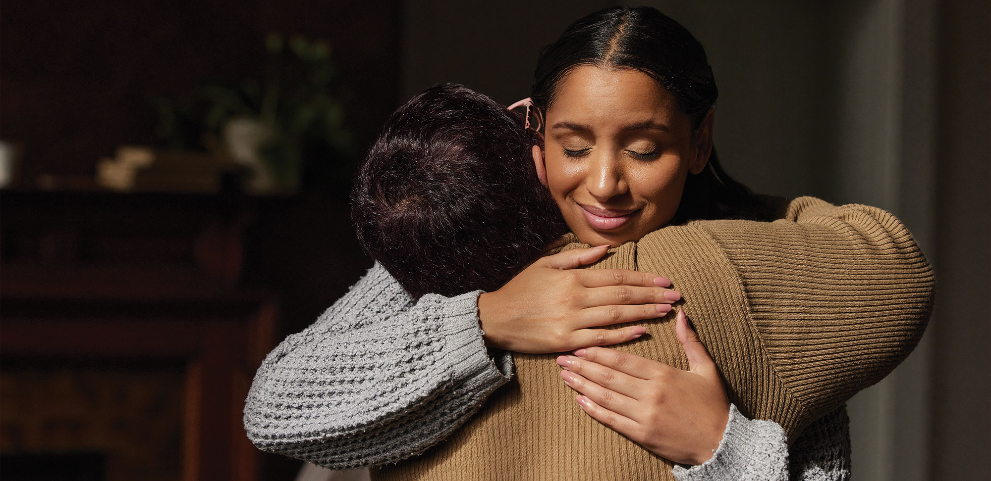 Photo of two woman hugging in support